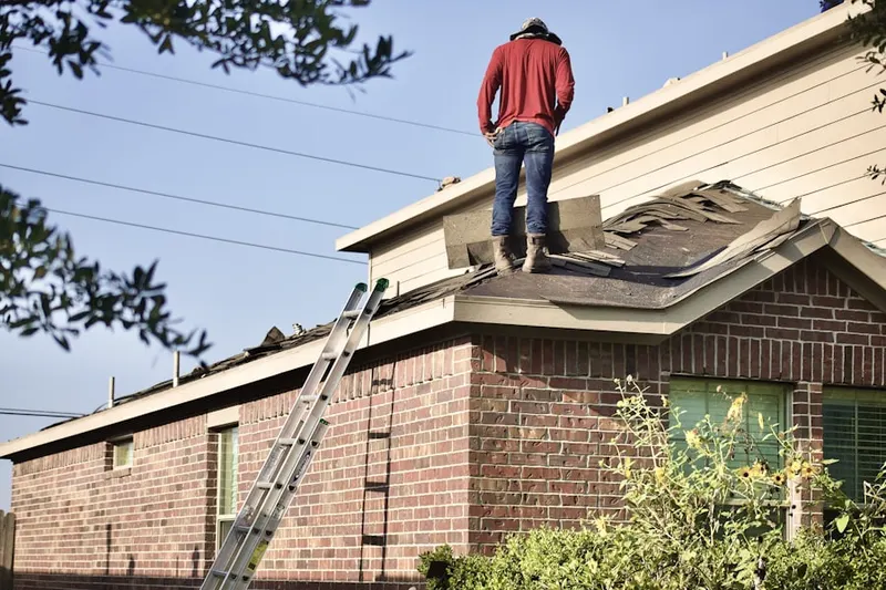 Professional roofer working on a residential roof in Mimosa Cove